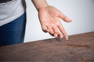 woman touching dusty table