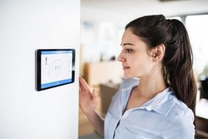 Woman looking at Thermostat