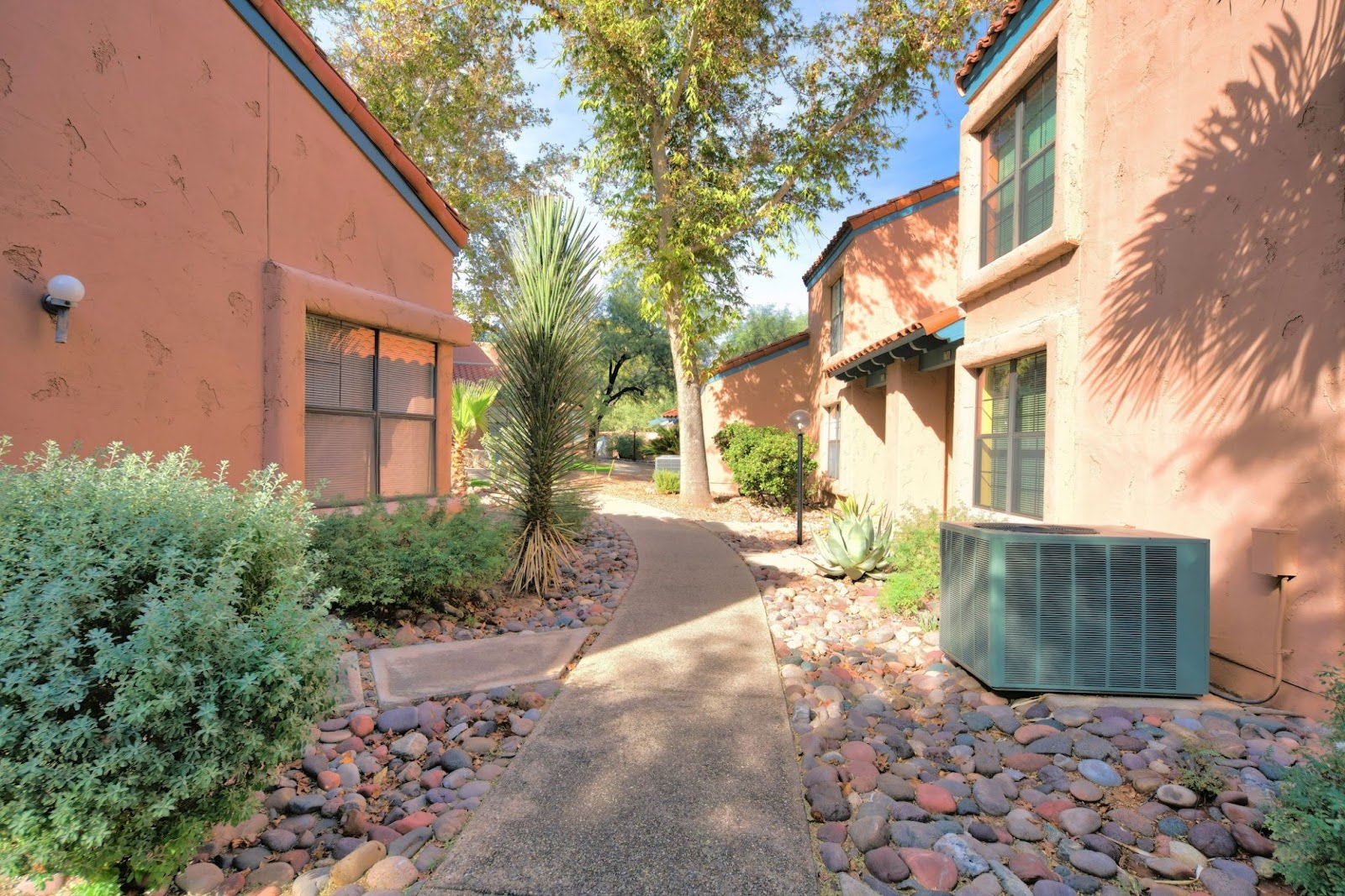 Narrow curved concrete path in the middle of houses in Arizona