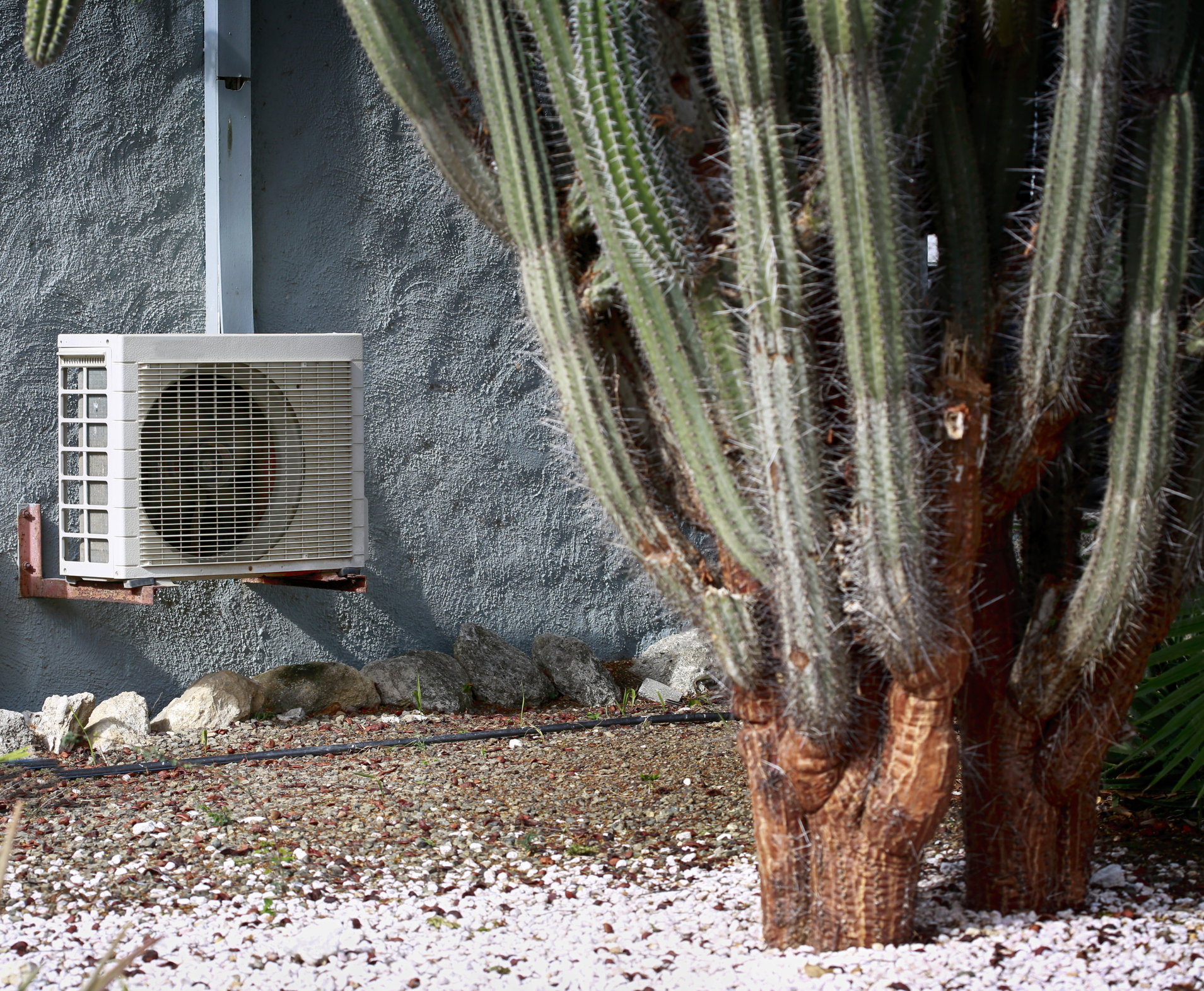 Air conditioner on stucco wall