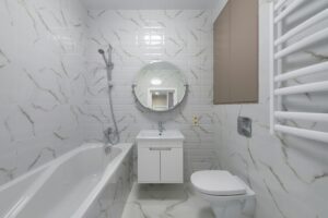 Modern bathroom with a toilet, sink, and bathtub—keeping drains clear prevents unexpected clogs.